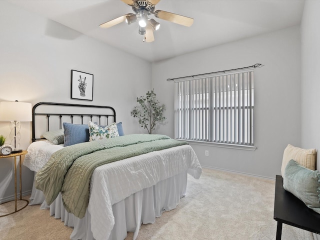 bedroom with light carpet and ceiling fan