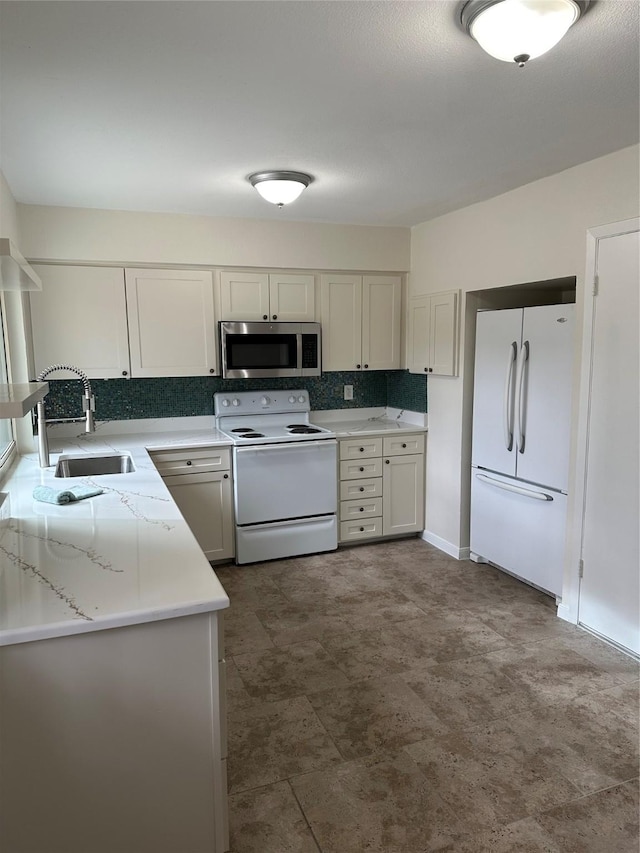 kitchen featuring white cabinets, white appliances, sink, and backsplash