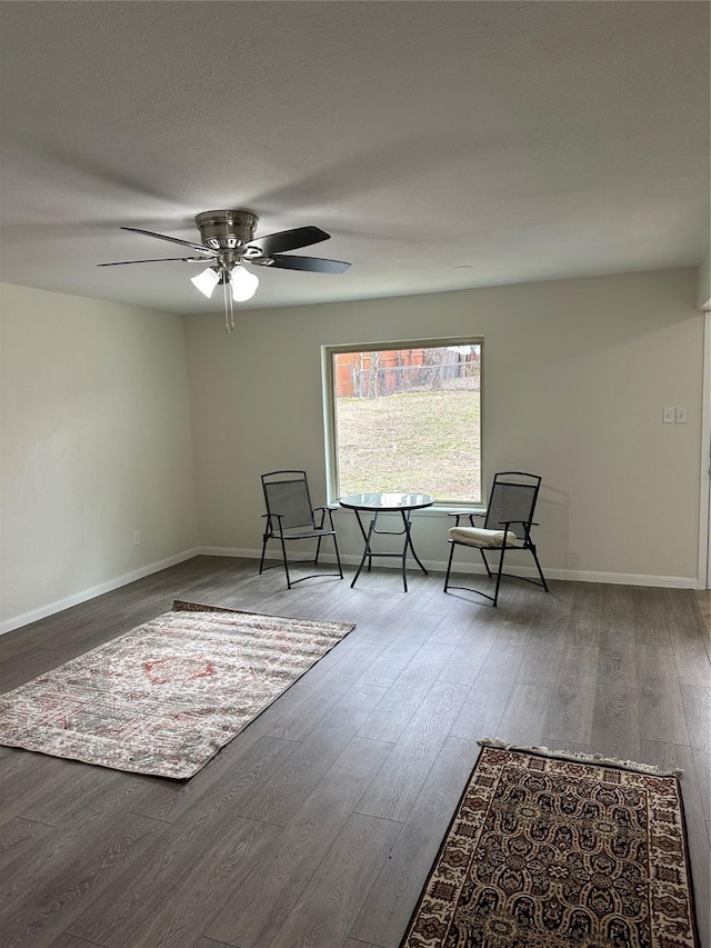 sitting room with hardwood / wood-style flooring and ceiling fan