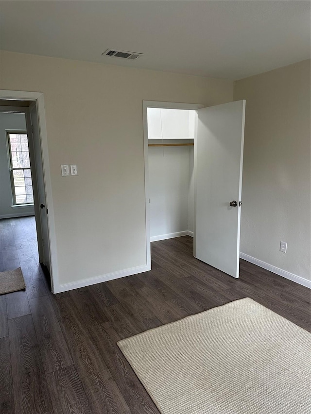 unfurnished room featuring dark wood-type flooring