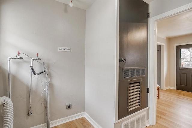 laundry area with light hardwood / wood-style flooring