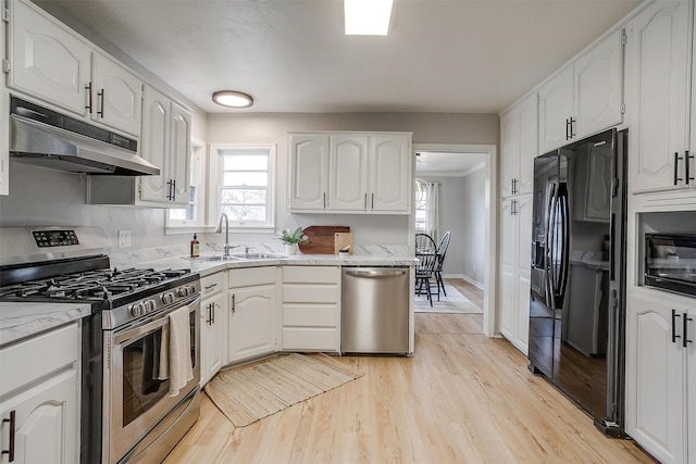 kitchen with sink, light hardwood / wood-style flooring, black appliances, and white cabinets