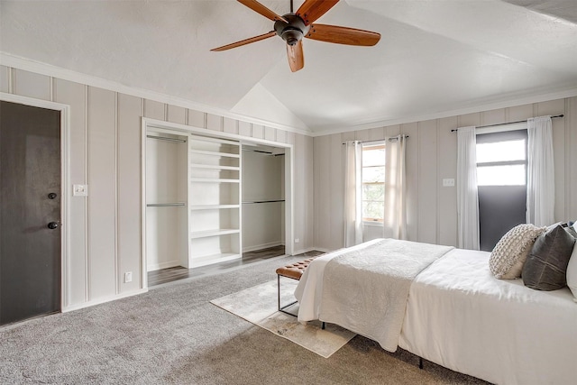 bedroom with lofted ceiling, carpet floors, ornamental molding, ceiling fan, and a closet