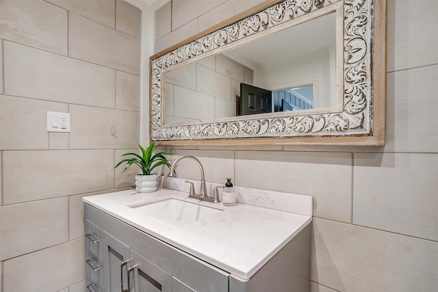 bathroom featuring vanity and tile walls