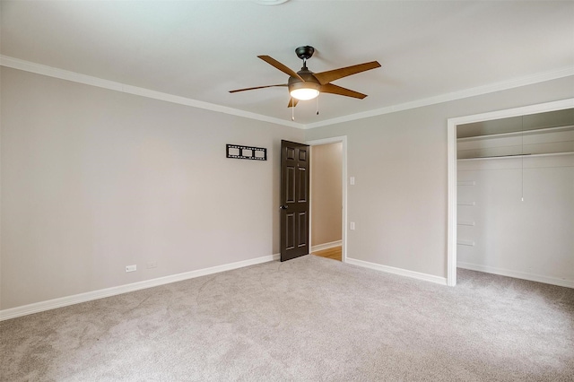 unfurnished bedroom featuring crown molding, light colored carpet, a closet, and ceiling fan