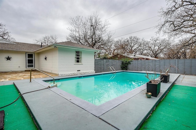 view of swimming pool with a patio