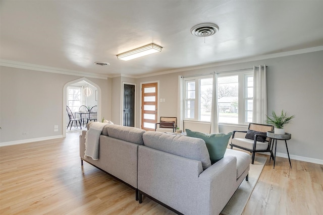 living room featuring crown molding and light wood-type flooring