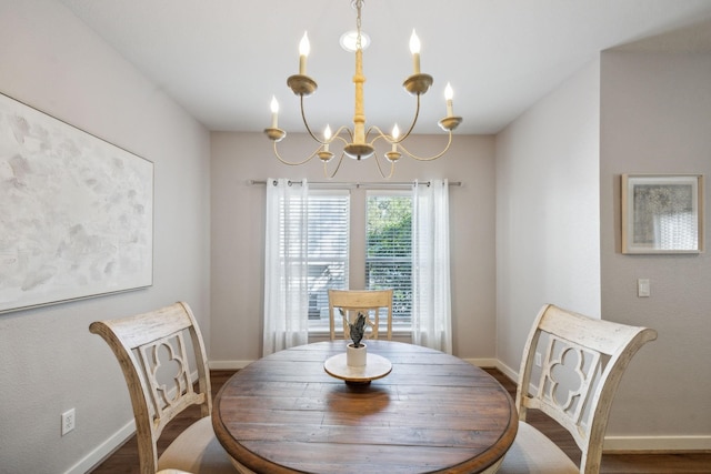 dining area featuring hardwood / wood-style flooring and a notable chandelier