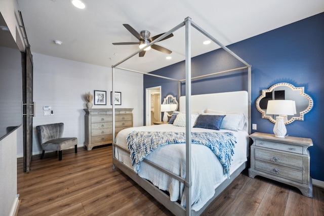 bedroom with ceiling fan and dark hardwood / wood-style flooring