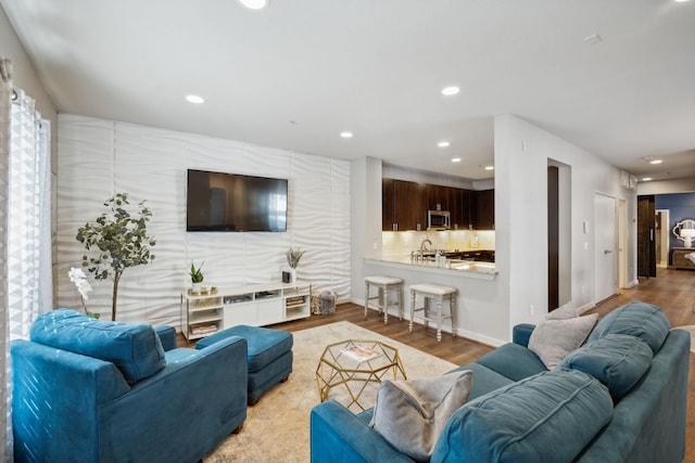 living room with sink and light hardwood / wood-style floors