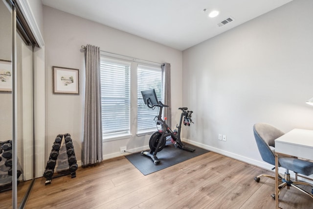 exercise area featuring light hardwood / wood-style flooring