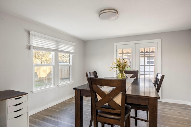 dining area with french doors and dark hardwood / wood-style floors