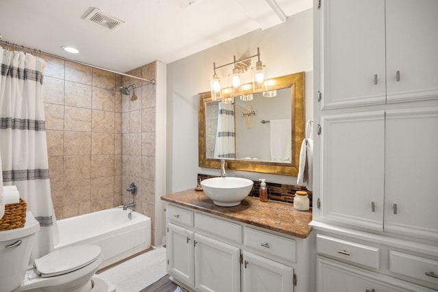 full bathroom with vanity, toilet, and shower / bath combo with shower curtain