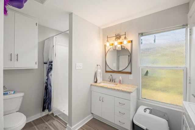 bathroom with vanity, a shower with curtain, wood-type flooring, and toilet