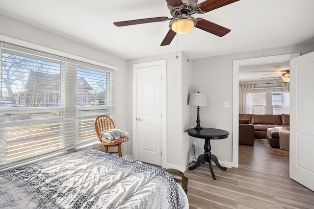 bedroom with ceiling fan and light hardwood / wood-style flooring