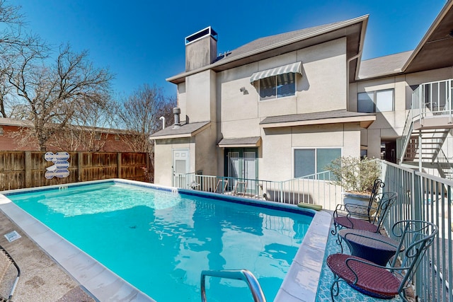 view of swimming pool featuring a fenced in pool and fence