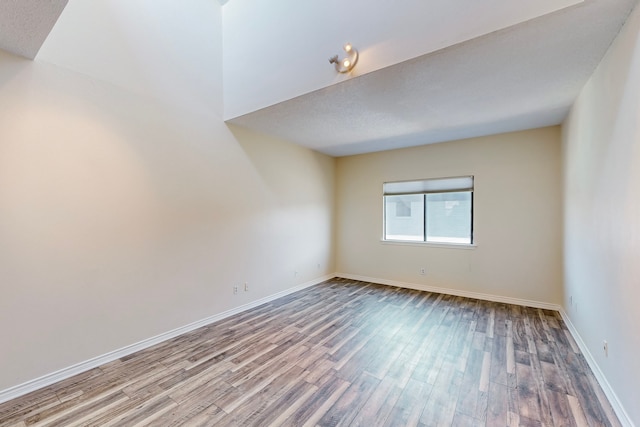 unfurnished room featuring wood finished floors and baseboards