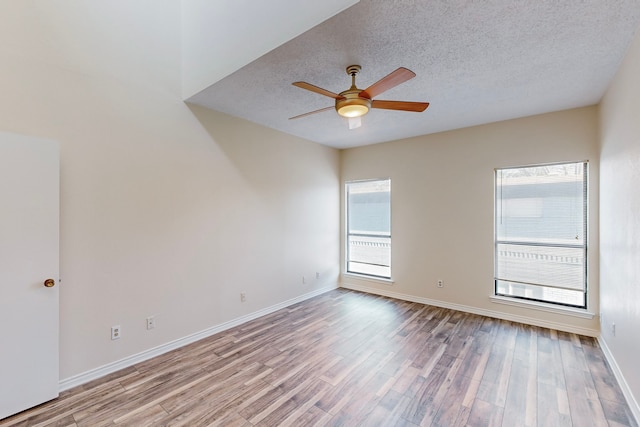 spare room featuring ceiling fan, a textured ceiling, and light hardwood / wood-style floors