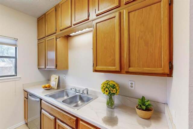 kitchen featuring black refrigerator, sink, light tile patterned floors, a textured ceiling, and electric stove