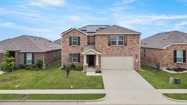 front of property with a garage, a front lawn, and solar panels