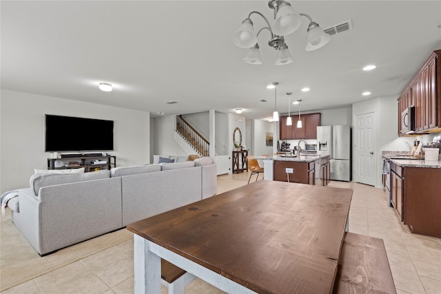 dining area with light tile patterned floors and sink