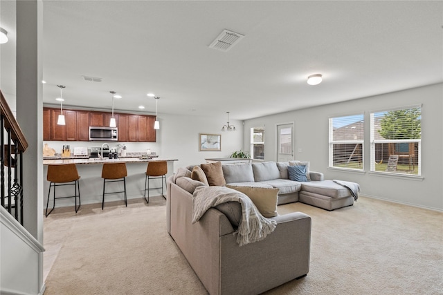 carpeted living room with sink and a healthy amount of sunlight