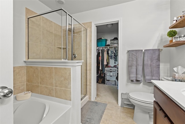 full bathroom with vanity, tile patterned floors, toilet, and separate shower and tub