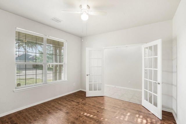 empty room with hardwood / wood-style flooring, french doors, and ceiling fan