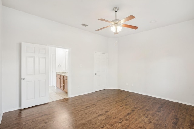 spare room with ceiling fan and light wood-type flooring