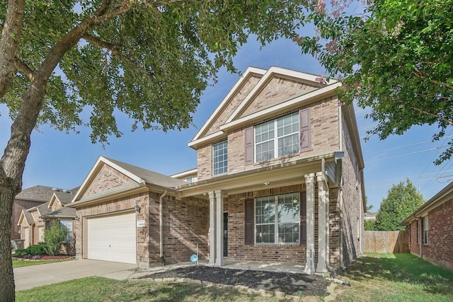 view of front of home featuring a garage, a porch, and a front yard