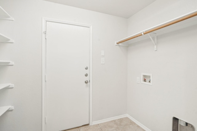 washroom with washer hookup and light tile patterned floors