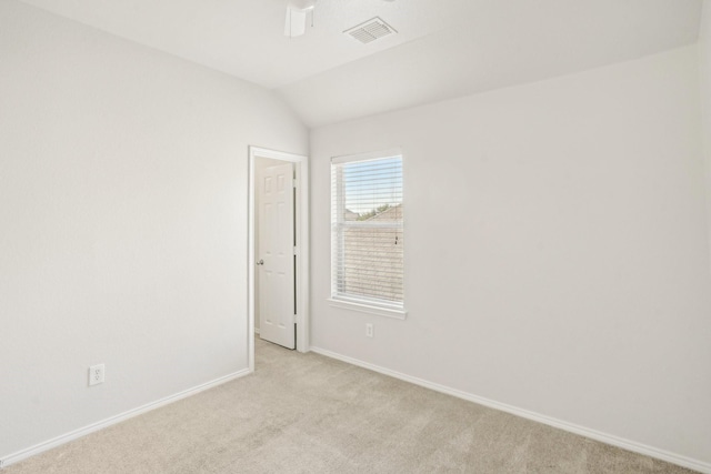 carpeted empty room featuring vaulted ceiling and ceiling fan