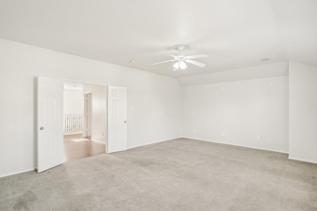 carpeted empty room featuring lofted ceiling and ceiling fan