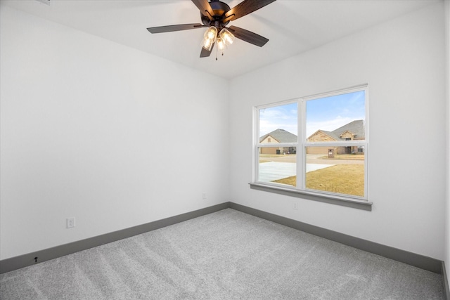 spare room with ceiling fan and carpet