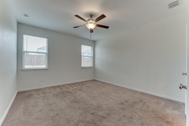 empty room featuring light carpet and ceiling fan