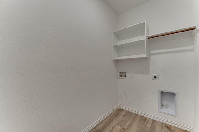 laundry room featuring hookup for a washing machine, hookup for a gas dryer, hookup for an electric dryer, and light hardwood / wood-style floors