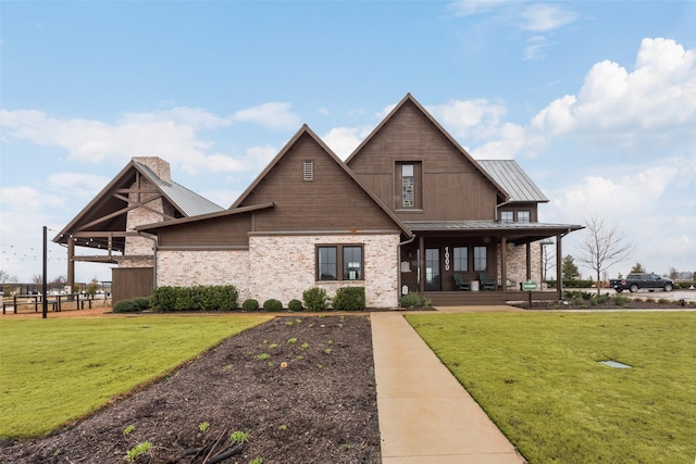 view of front of house with covered porch and a front lawn