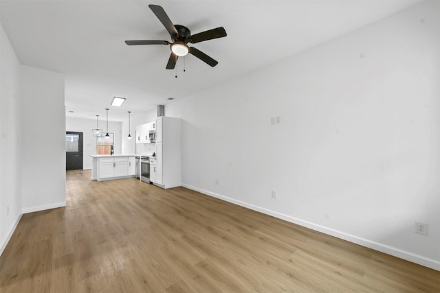 unfurnished living room featuring ceiling fan and light hardwood / wood-style flooring