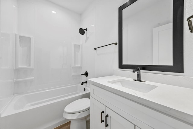 full bathroom featuring bathing tub / shower combination, vanity, and toilet