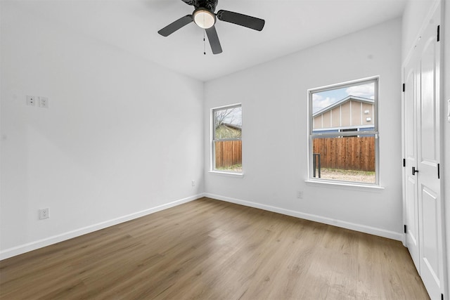 spare room featuring light hardwood / wood-style flooring and ceiling fan