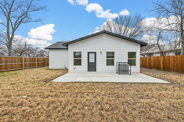 rear view of house featuring a yard and a patio