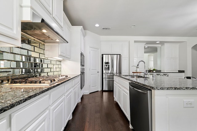 kitchen with sink, appliances with stainless steel finishes, white cabinetry, an island with sink, and custom exhaust hood