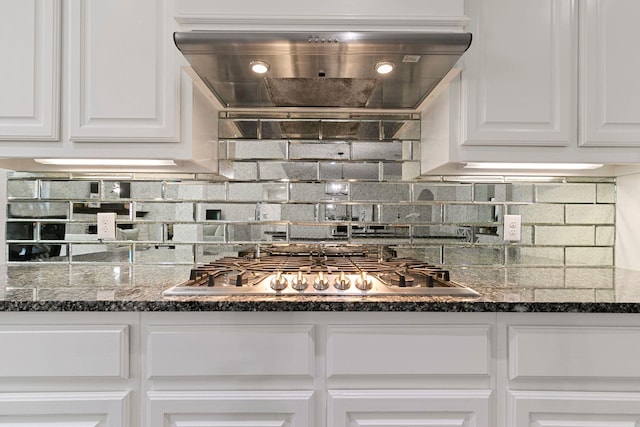 kitchen featuring white cabinetry, stainless steel gas cooktop, custom exhaust hood, and backsplash