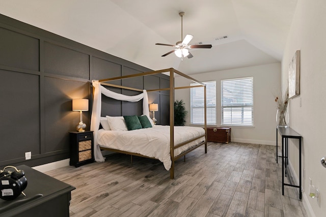 bedroom with wood-type flooring, lofted ceiling, and ceiling fan