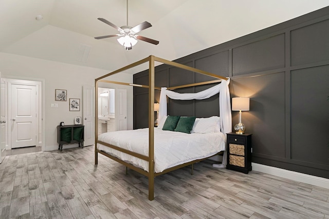 bedroom featuring lofted ceiling, light hardwood / wood-style flooring, and ceiling fan