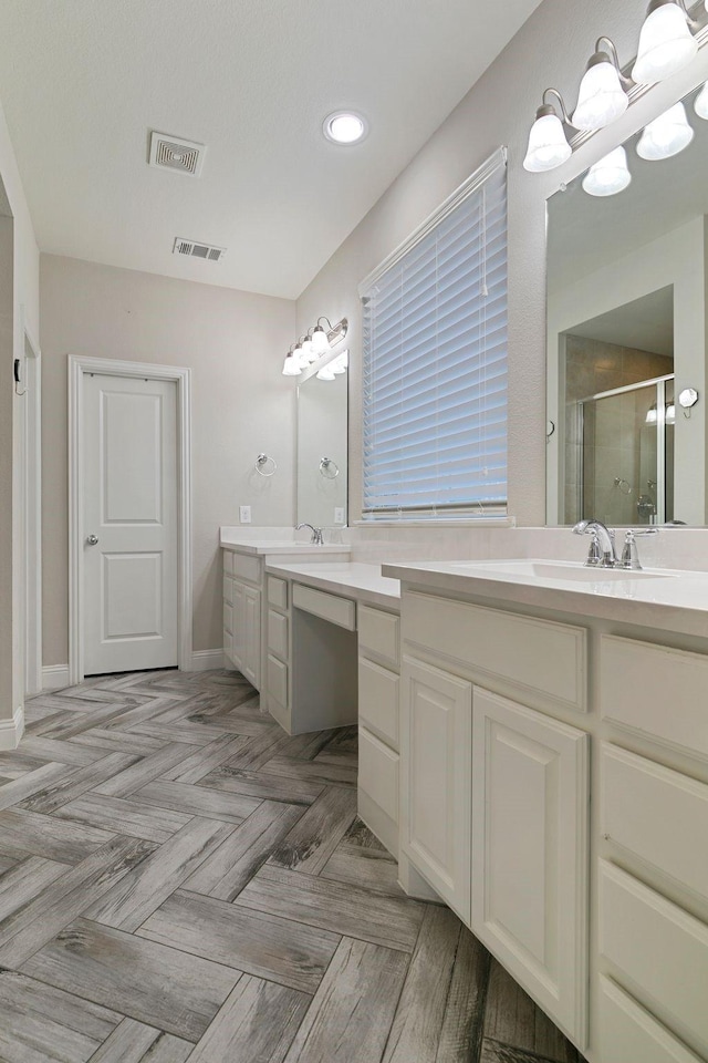 bathroom featuring vanity, parquet flooring, and walk in shower