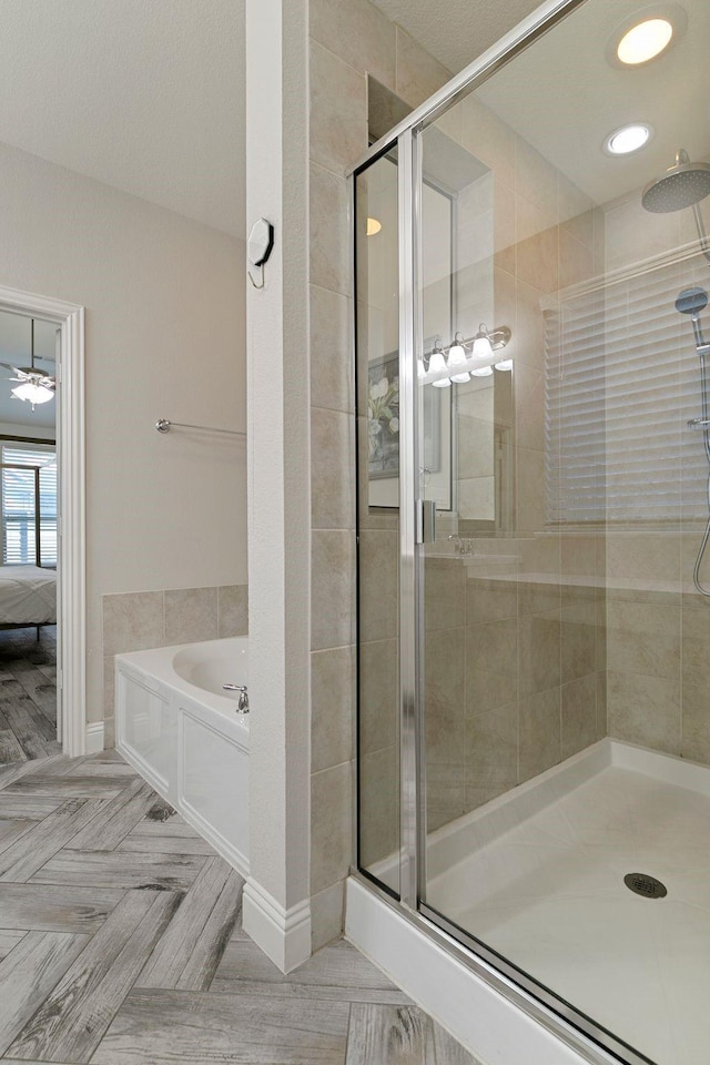 bathroom with separate shower and tub