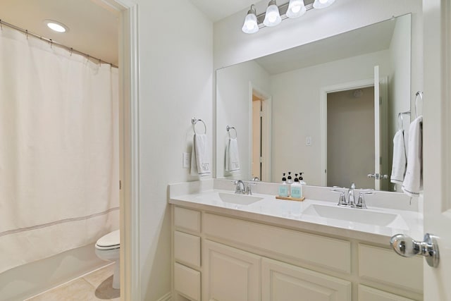 bathroom featuring vanity, toilet, and tile patterned flooring