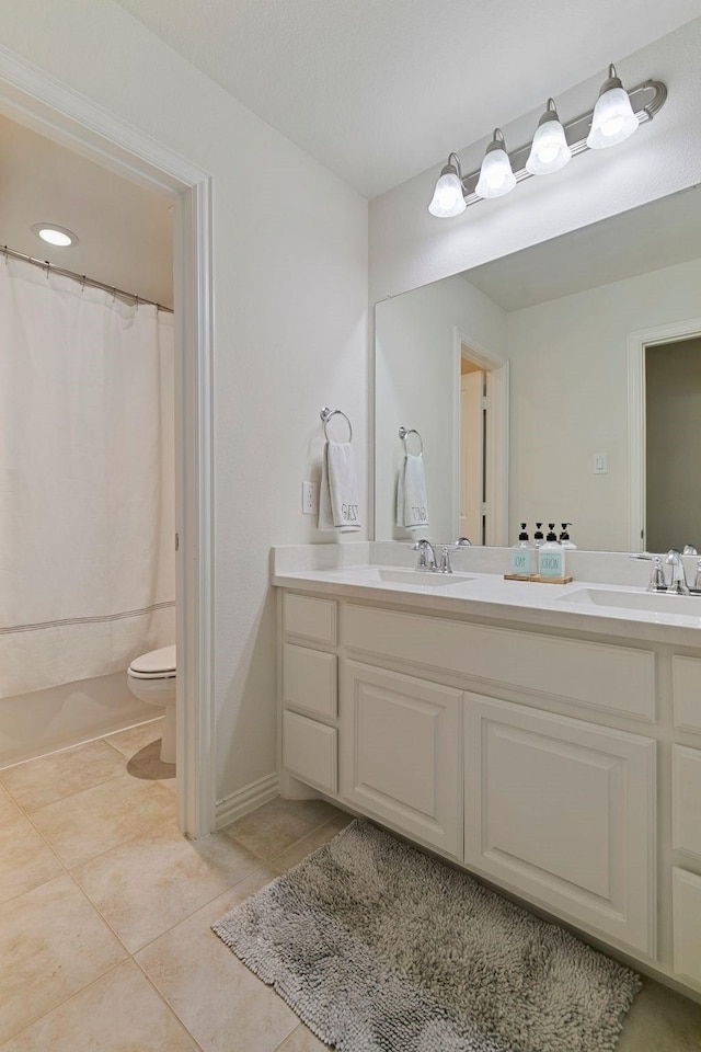 bathroom with vanity, walk in shower, tile patterned floors, and toilet