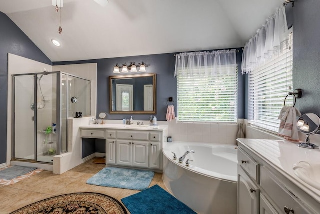 bathroom with vanity, vaulted ceiling, tile patterned floors, and plus walk in shower